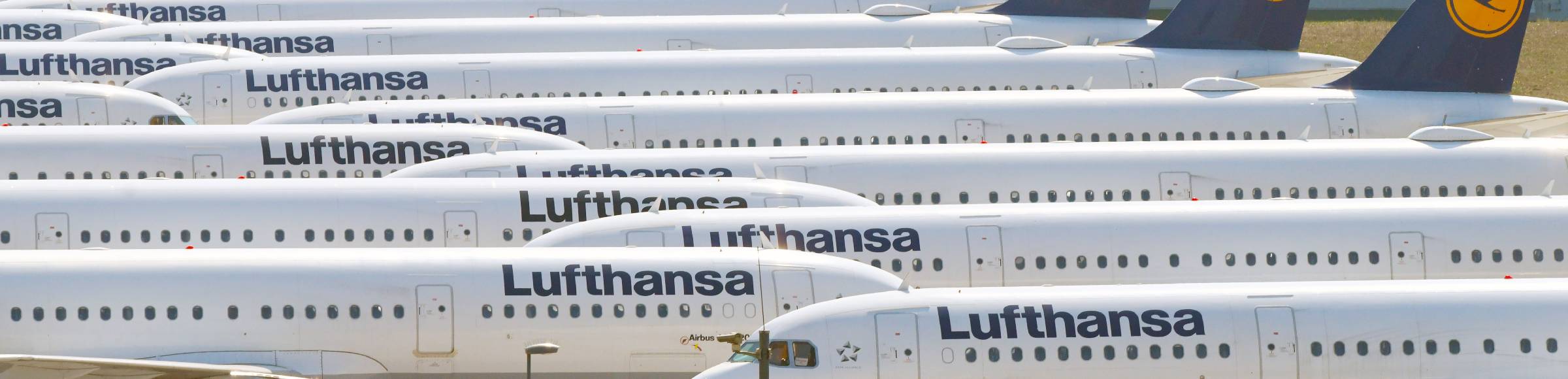 Decommissioned due to crisis passenger airplanes of the airline Lufthansa in parking position - parking area at the BER - airport in Schoenefeld in the state Brandenburg, Germany